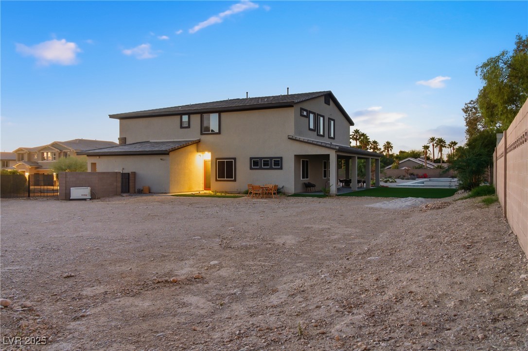 7736 Tioga Ridge Las Vegas, NV 89117 - Photo 63 of 68 Back of property with stucco siding and a patio area