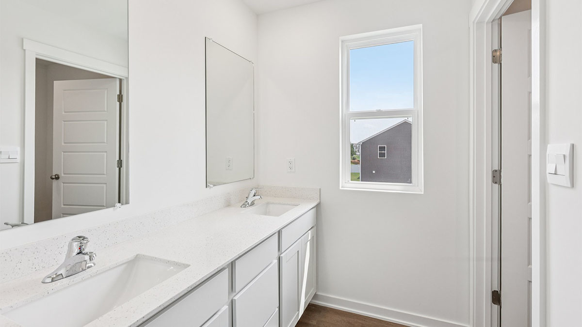 2516 Winterberry Trail Wonder Lake, IL 60097 - Photo 28 of 68 a bathroom with a double vanity sink and a mirror
