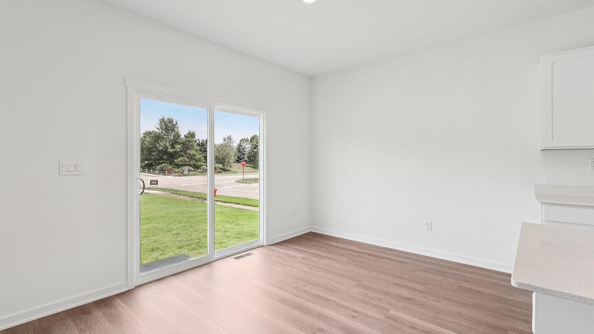2516 Winterberry Trail Wonder Lake, IL 60097 - Photo 9 of 68 a view of an empty room with wooden floor and a window