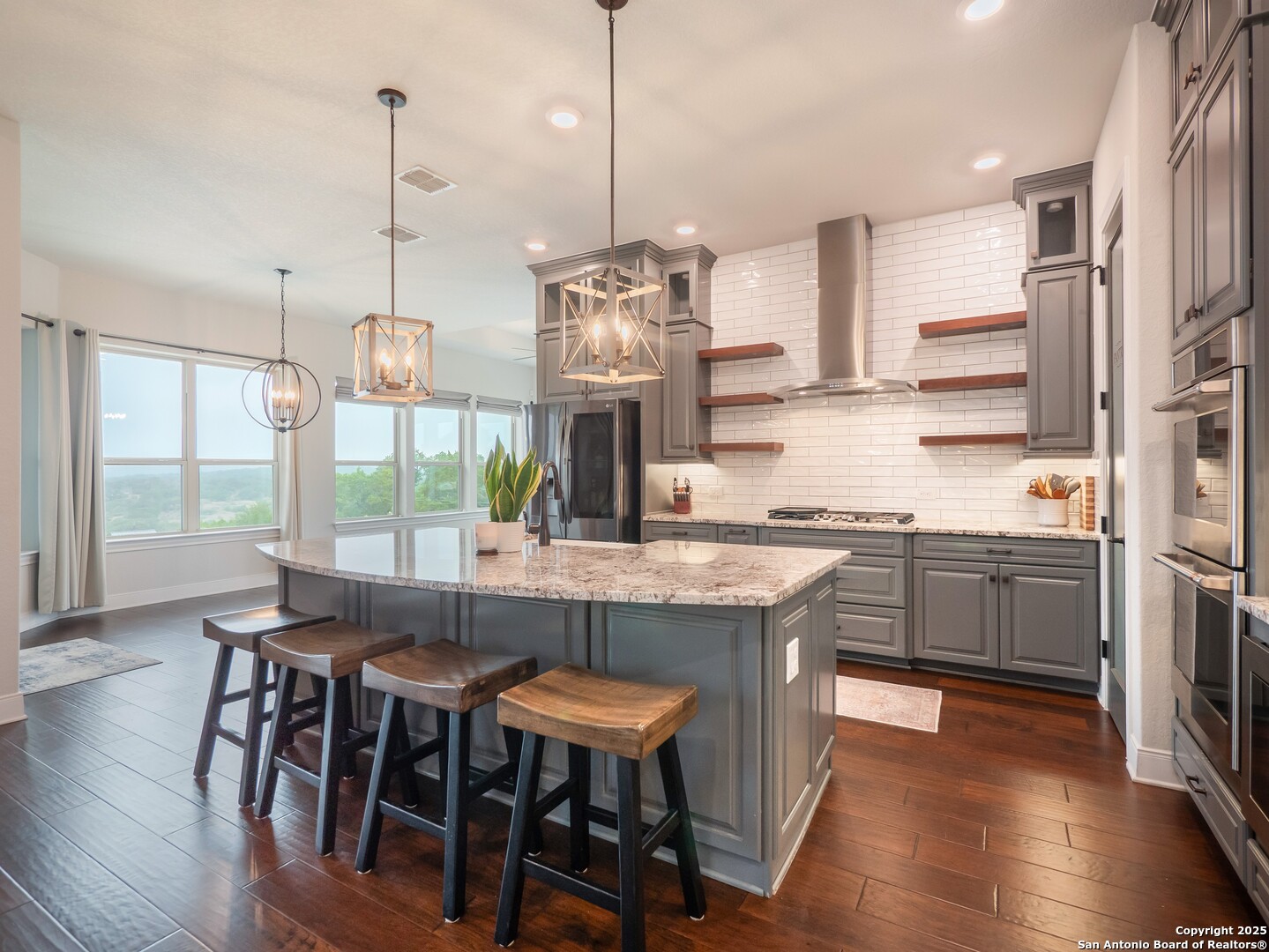 632 Carson Ridge New Braunfels, TX 78132 - Photo 14 of 57 a kitchen with stainless steel appliances granite countertop a kitchen island hardwood floor and a sink