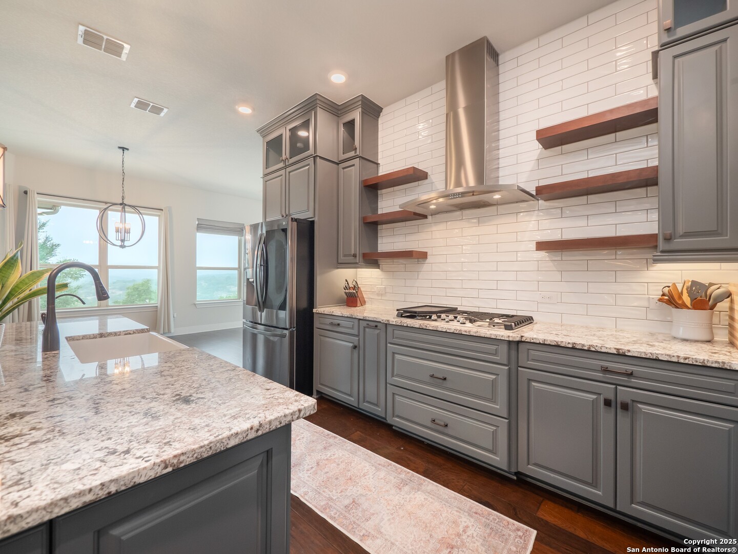 632 Carson Ridge New Braunfels, TX 78132 - Photo 15 of 57 a kitchen with stainless steel appliances granite countertop a sink a stove and a wooden cabinets