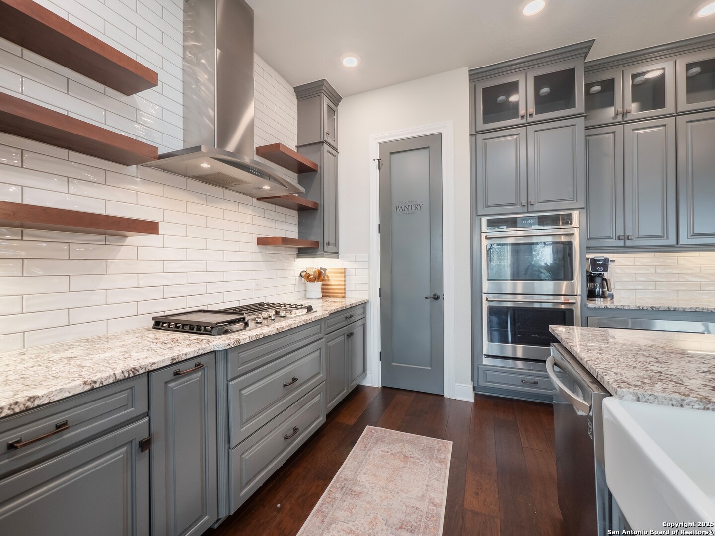 632 Carson Ridge New Braunfels, TX 78132 - Photo 16 of 57 a kitchen with stainless steel appliances granite countertop a stove and a refrigerator