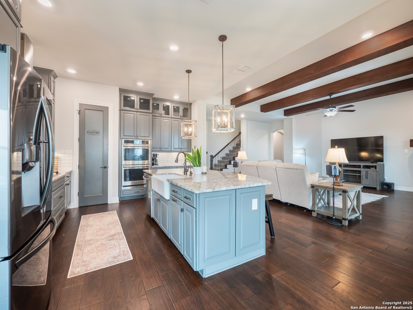632 Carson Ridge New Braunfels, TX 78132 - Photo 17 of 57 a kitchen with stainless steel appliances granite countertop a sink counter space and wooden floor