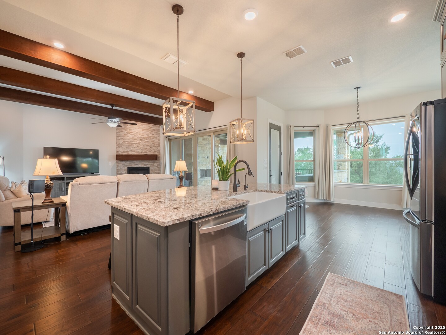 632 Carson Ridge New Braunfels, TX 78132 - Photo 18 of 57 a kitchen with stainless steel appliances granite countertop a kitchen island a stove and a wooden floors