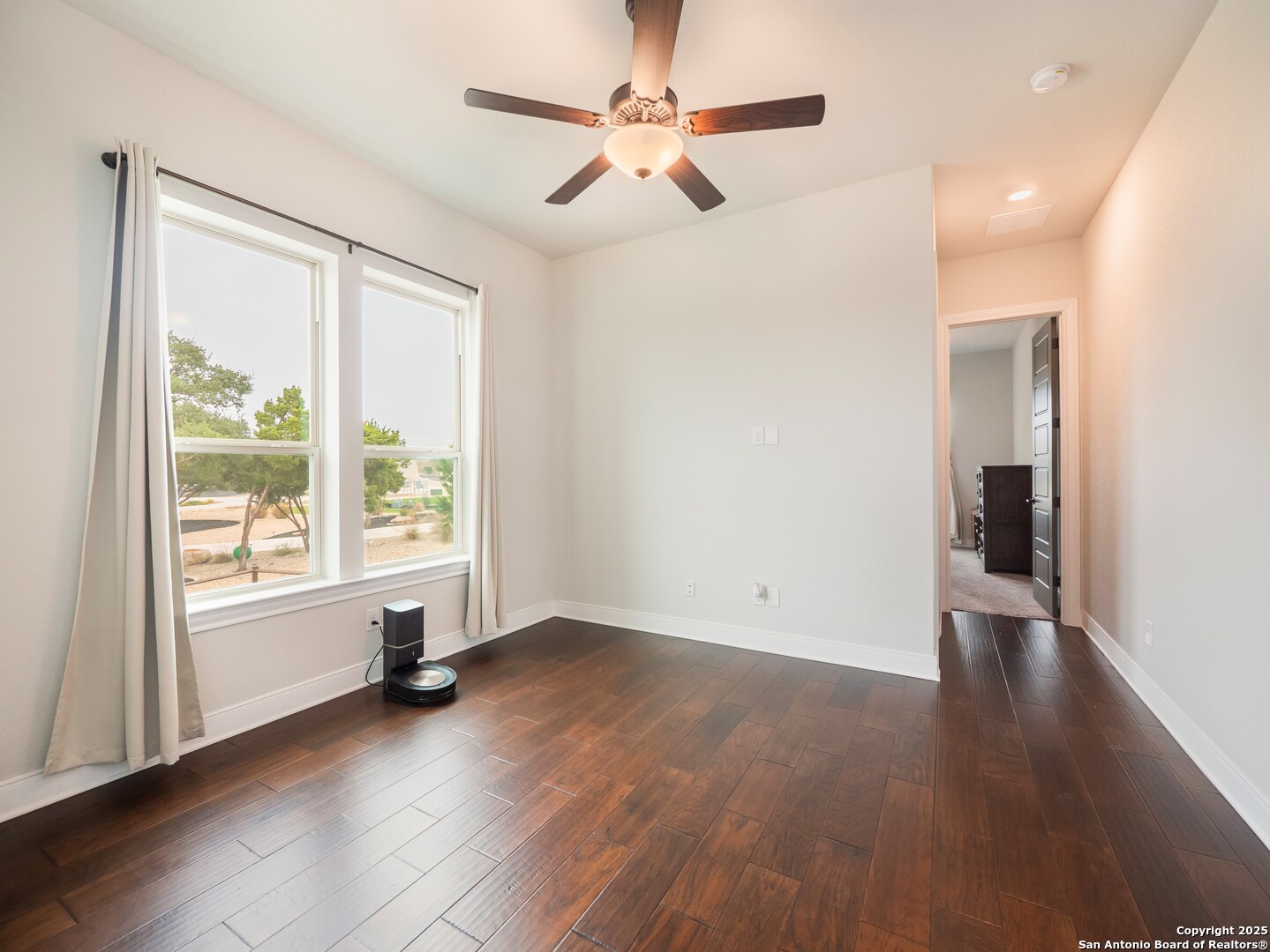 632 Carson Ridge New Braunfels, TX 78132 - Photo 30 of 57 wooden floor in an empty room with a window