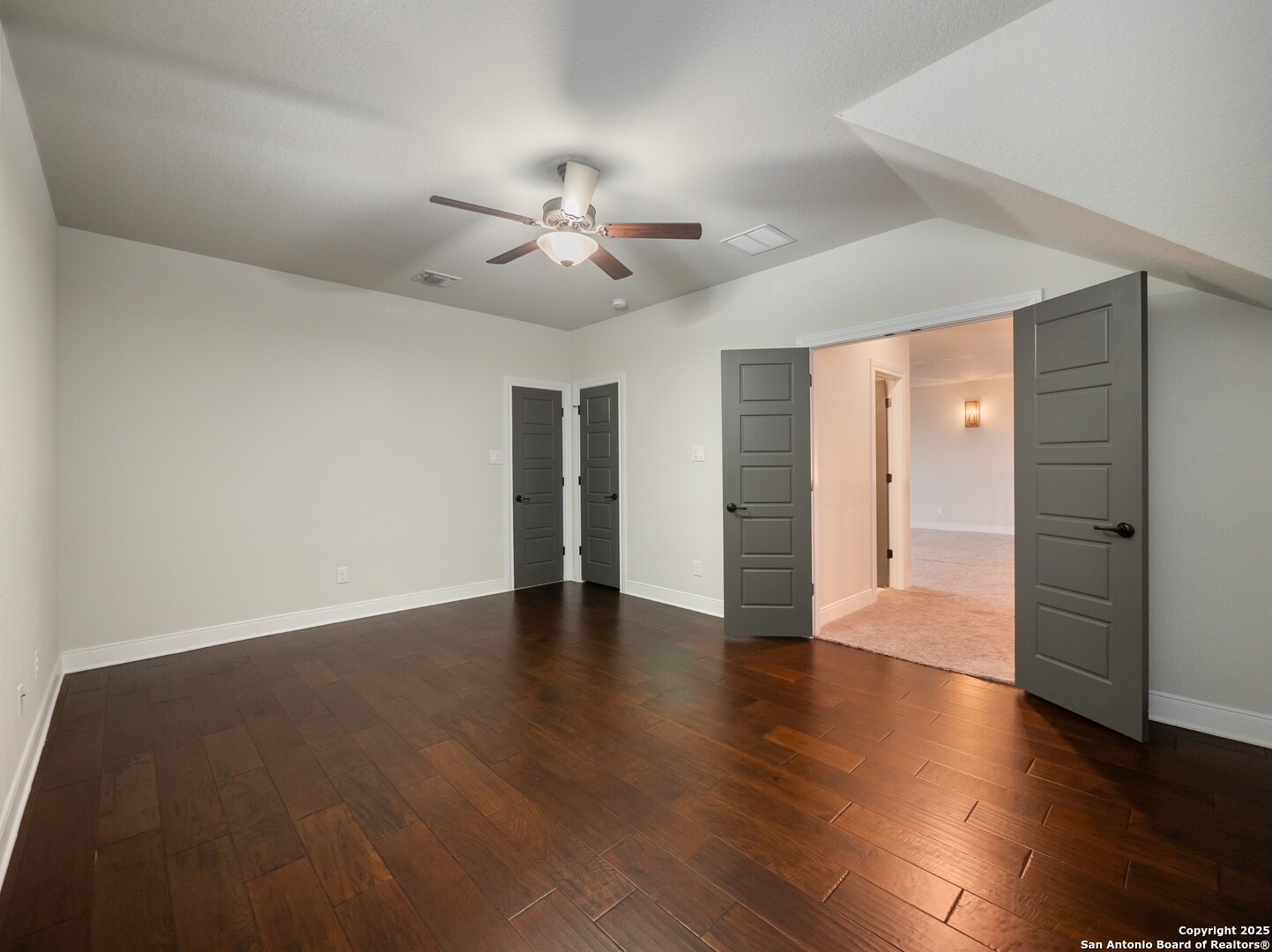 632 Carson Ridge New Braunfels, TX 78132 - Photo 41 of 57 a view of an empty room with wooden floor and a ceiling fan