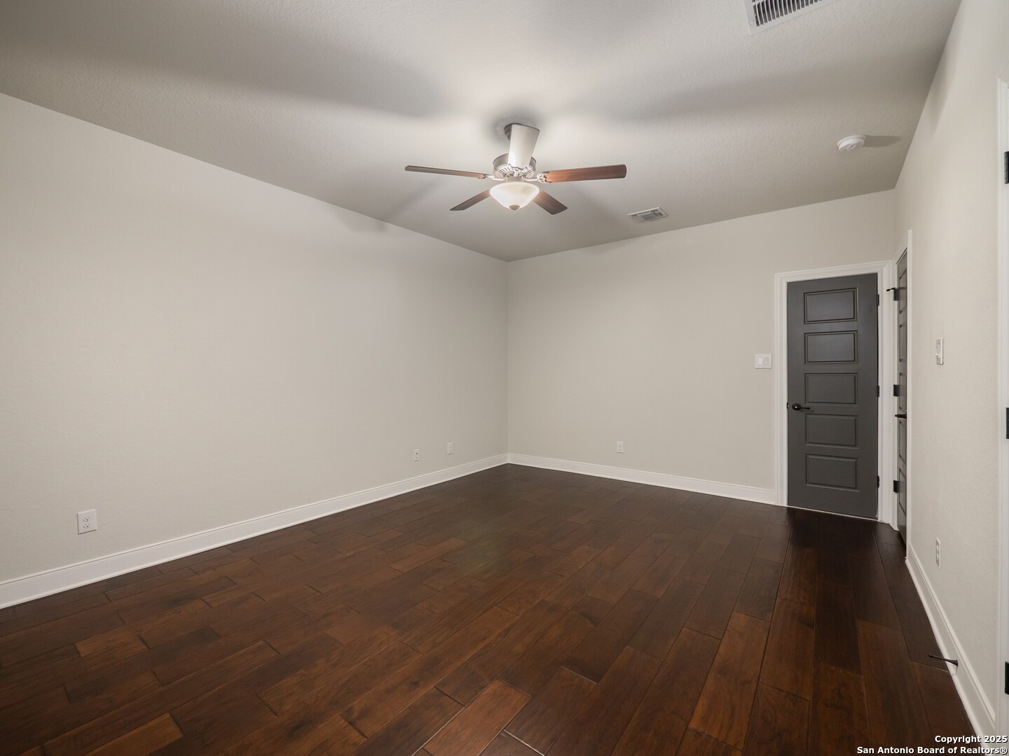632 Carson Ridge New Braunfels, TX 78132 - Photo 42 of 57 an empty room with wooden floor ceiling fan and windows