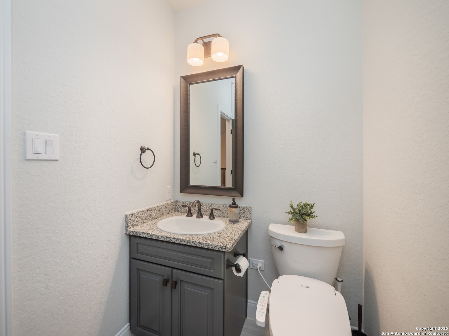 632 Carson Ridge New Braunfels, TX 78132 - Photo 43 of 57 a bathroom with a toilet sink and mirror