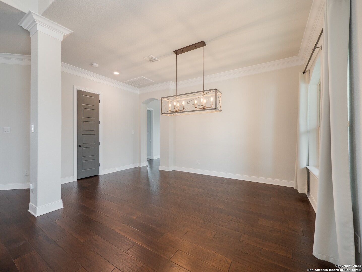632 Carson Ridge New Braunfels, TX 78132 - Photo 6 of 57 a view of an empty room with wooden floor and a window