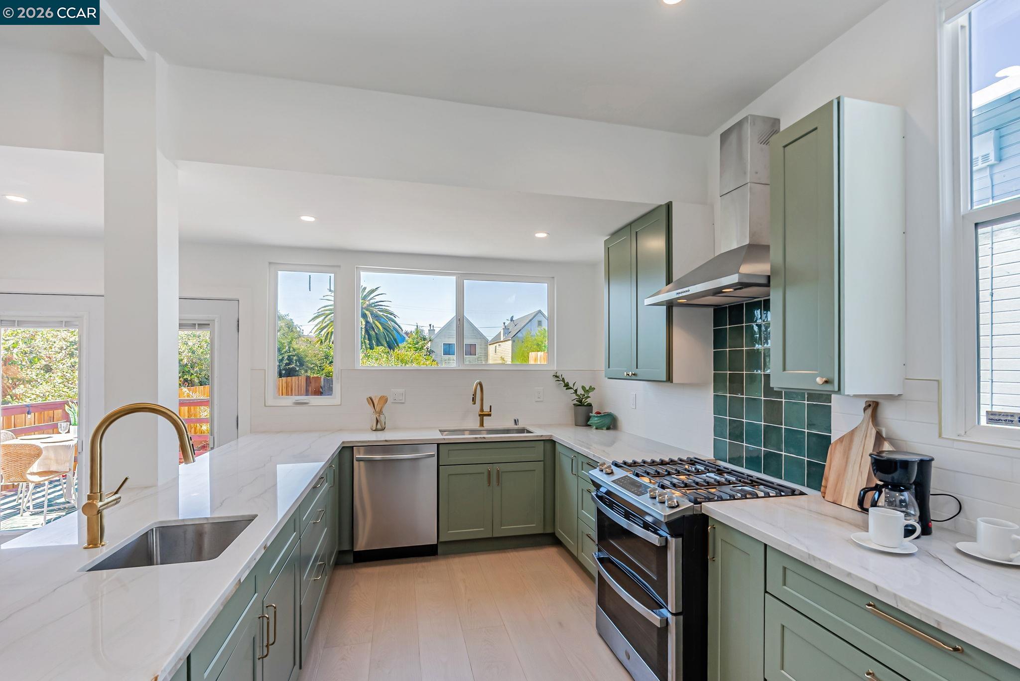 1727 9th Street Oakland, CA 94607 - Photo 11 of 36 a view of a kitchen with a sink and a stove top oven