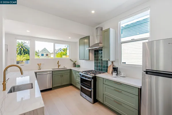 a kitchen with a sink appliances and cabinets