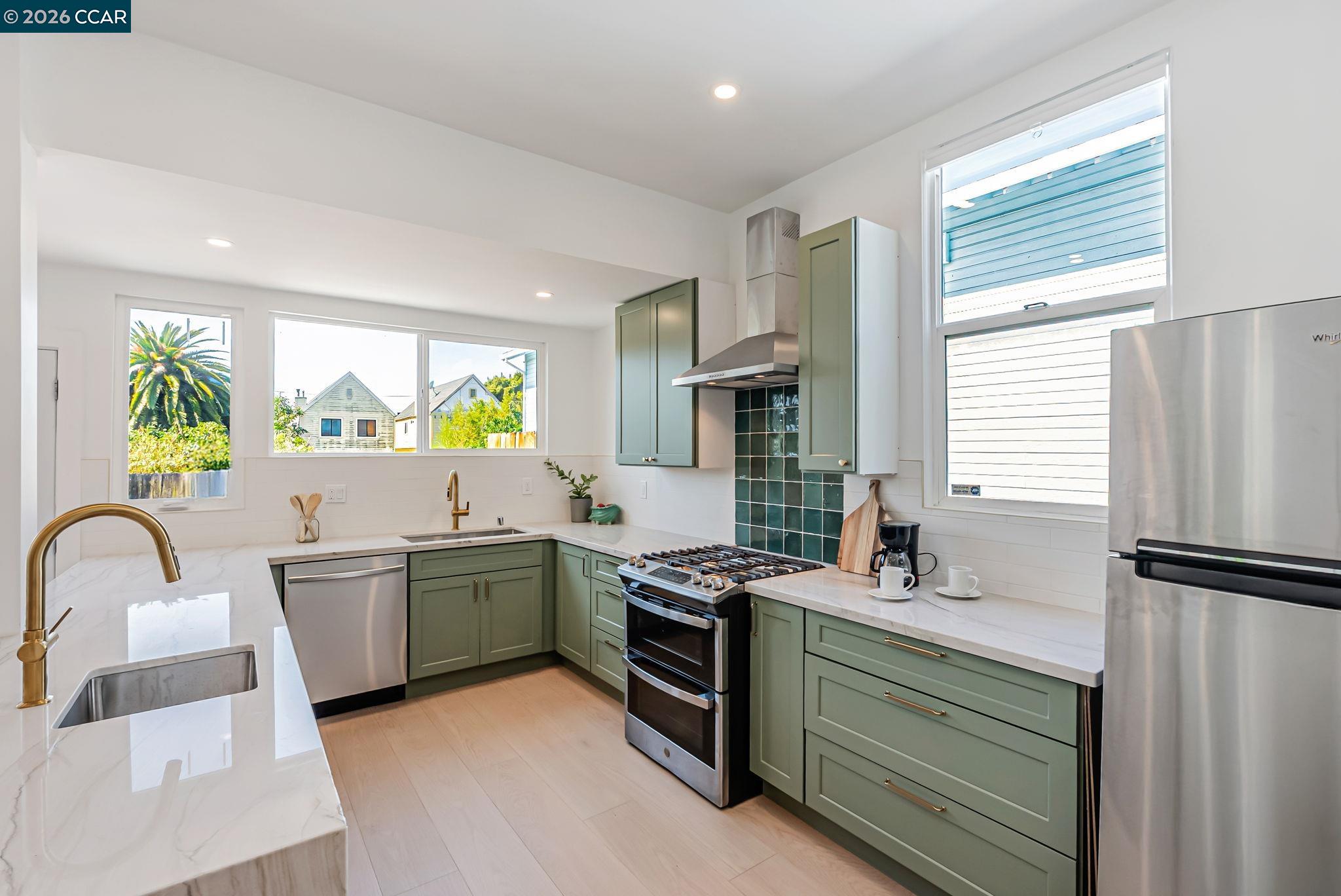 1727 9th Street Oakland, CA 94607 - Photo 12 of 36 a kitchen with a sink appliances and cabinets