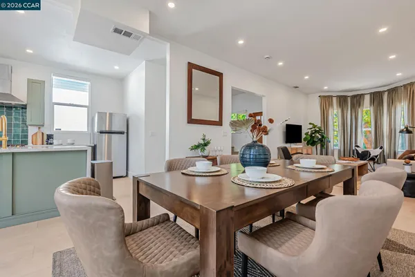a view of a dining room with furniture and a potted plant
