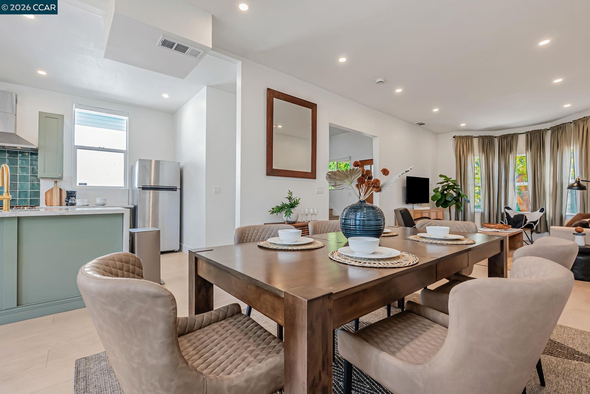 1727 9th Street Oakland, CA 94607 - Photo 15 of 36 a view of a dining room with furniture and a potted plant