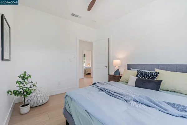 a bedroom with a bed and a potted plant