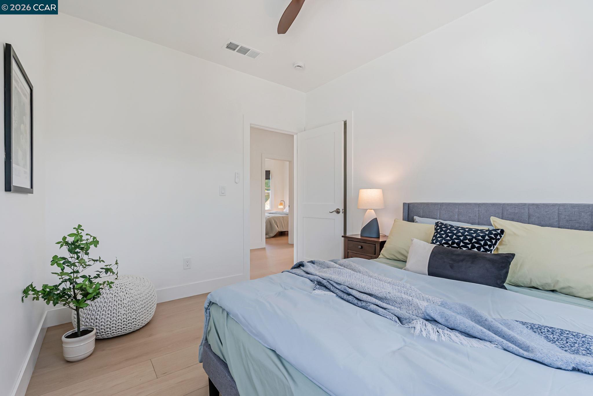 1727 9th Street Oakland, CA 94607 - Photo 19 of 36 a bedroom with a bed and a potted plant