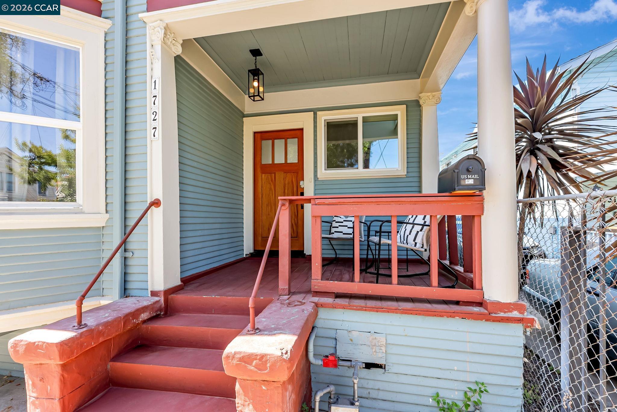 1727 9th Street Oakland, CA 94607 - Photo 2 of 36 a view of a house with a large window and flower plants
