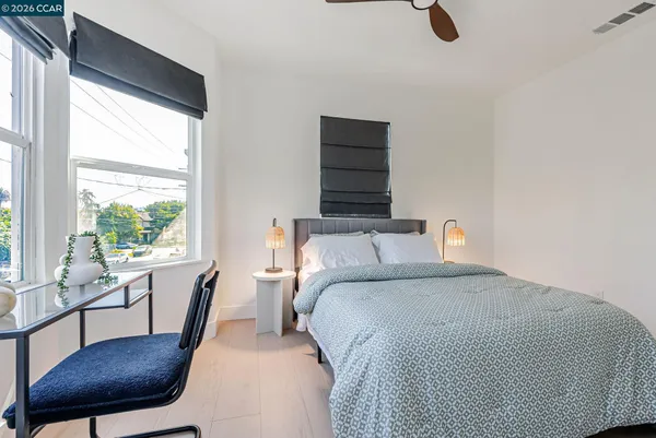 a bedroom with a bed and a chair