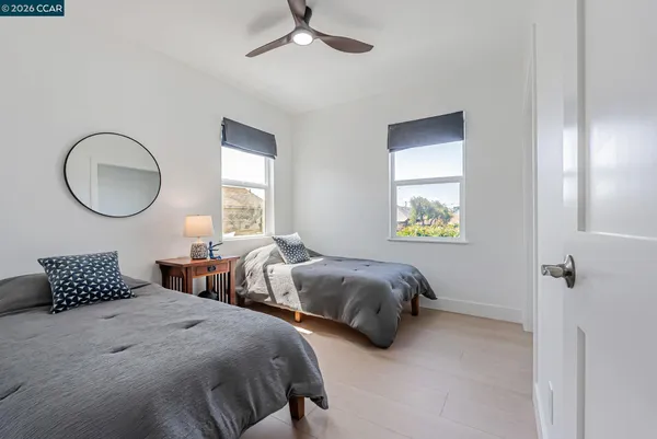 a bedroom with two beds and a chandelier
