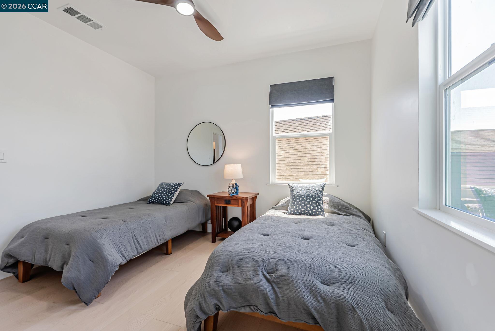 1727 9th Street Oakland, CA 94607 - Photo 24 of 36 a bedroom with two beds and windows