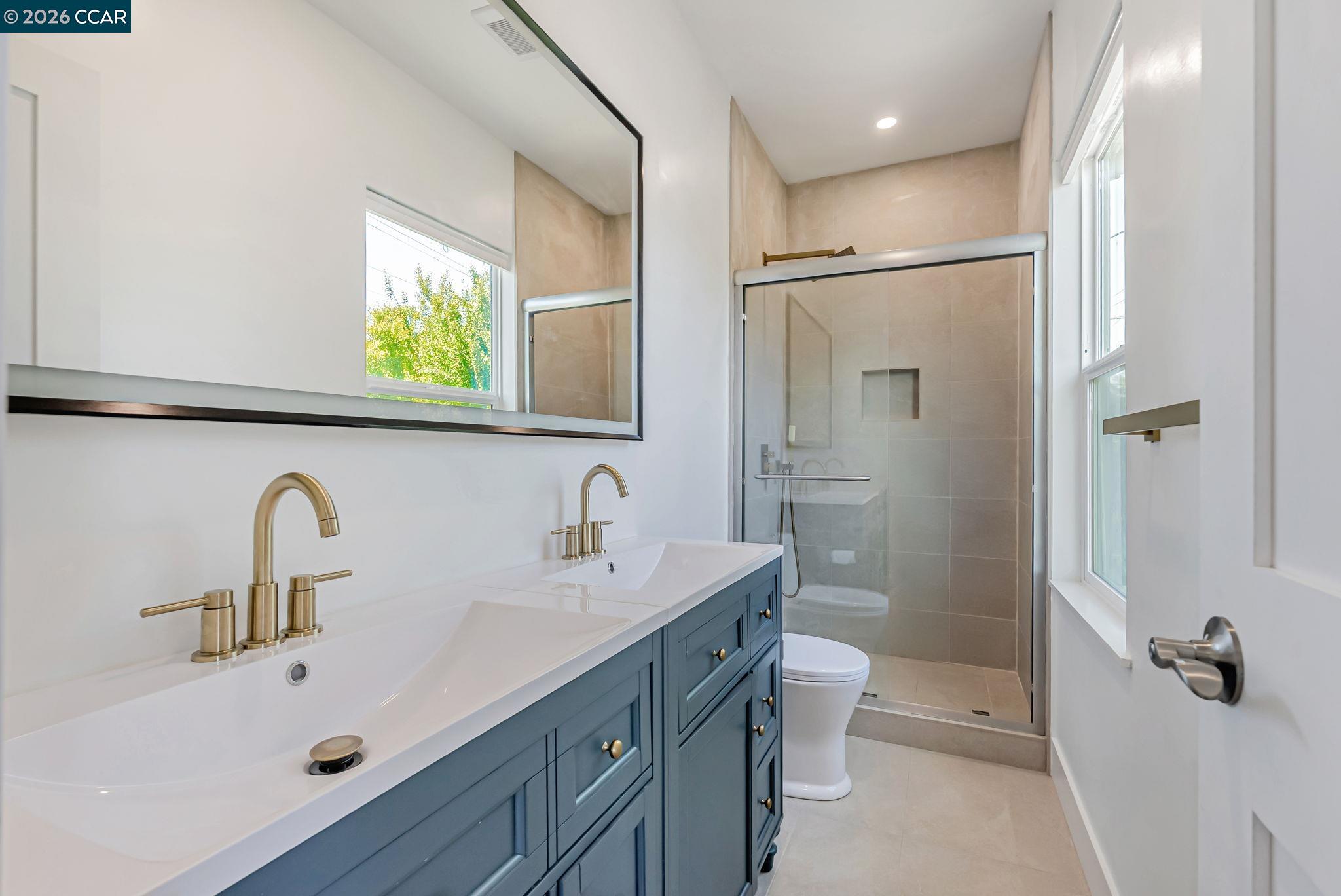 1727 9th Street Oakland, CA 94607 - Photo 25 of 36 a bathroom with a sink a toilet and shower