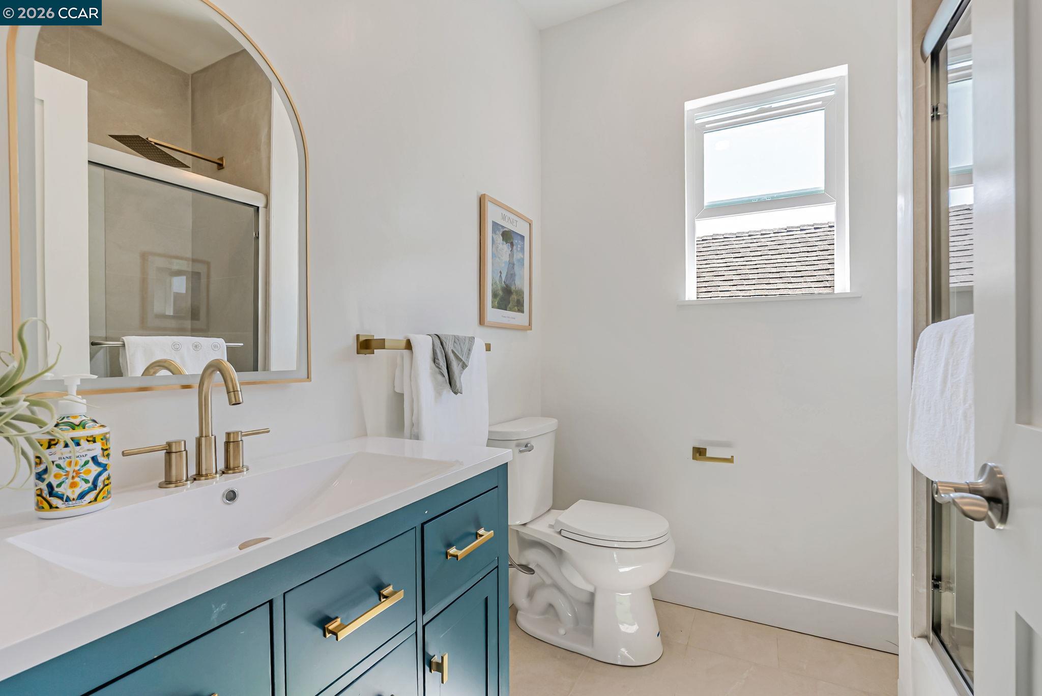 1727 9th Street Oakland, CA 94607 - Photo 26 of 36 a bathroom with a toilet sink and mirror