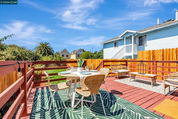 a backyard of a house with barbeque oven table and chairs