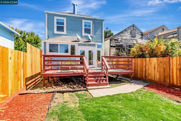 a view of a backyard with wooden fence