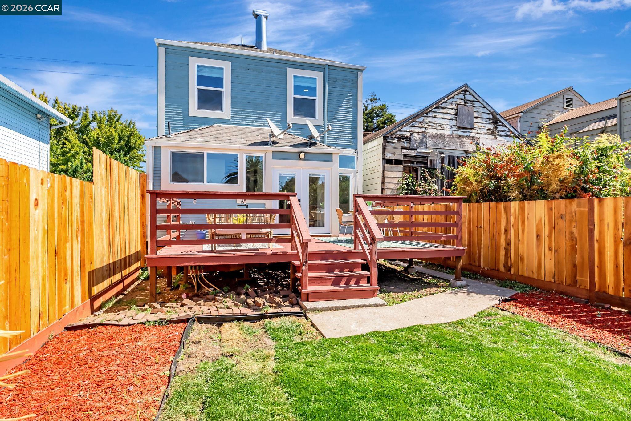 1727 9th Street Oakland, CA 94607 - Photo 32 of 36 a front view of a house with a yard table and chairs