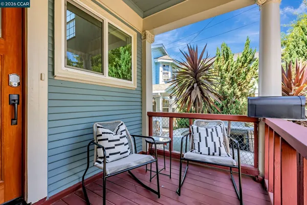a view of a chairs and table in the balcony