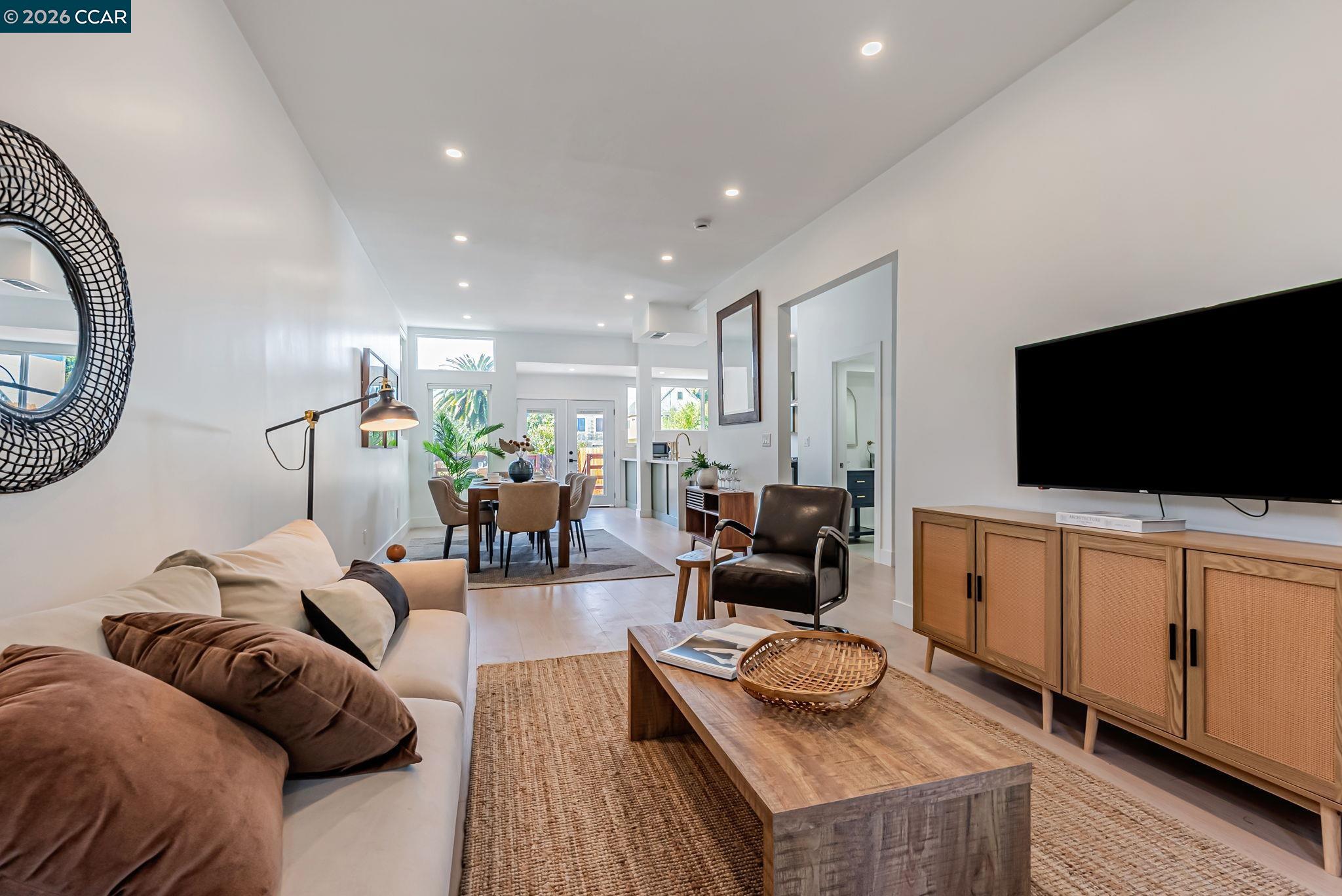 1727 9th Street Oakland, CA 94607 - Photo 7 of 36 a living room with furniture and a flat screen tv