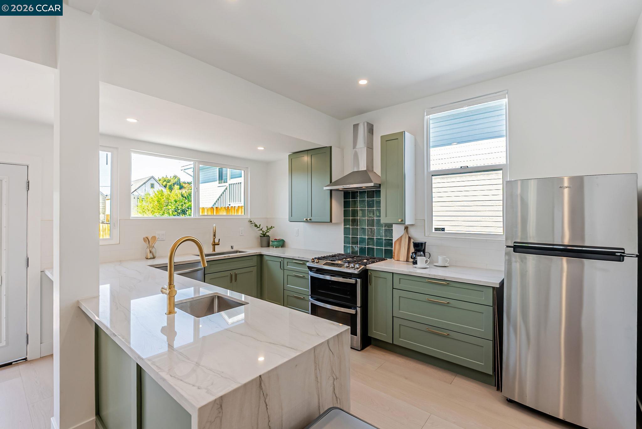 1727 9th Street Oakland, CA 94607 - Photo 9 of 36 a kitchen with a sink appliances and cabinets