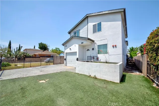 a view of a house with a yard and sitting area