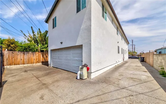 a view of a garage with wooden fence