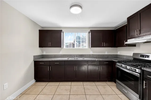 a kitchen with a sink and a stove top oven