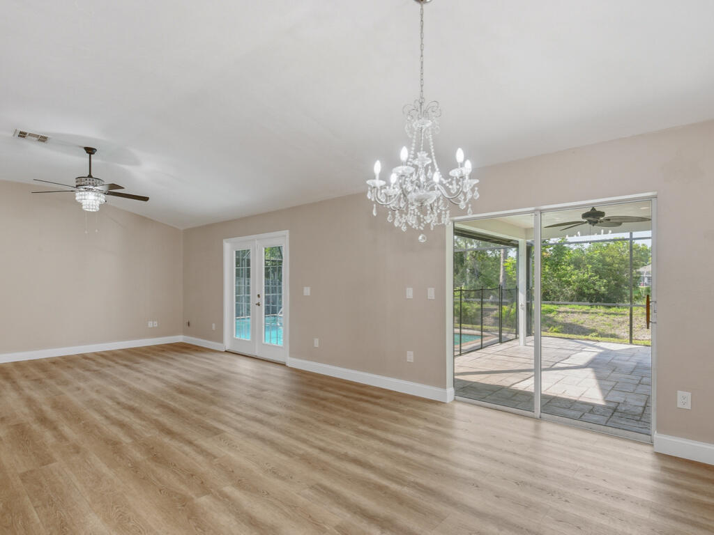3650 Kent Drive Naples, FL 34112 - Photo 5 of 17 a view of an empty room with wooden floor and a window