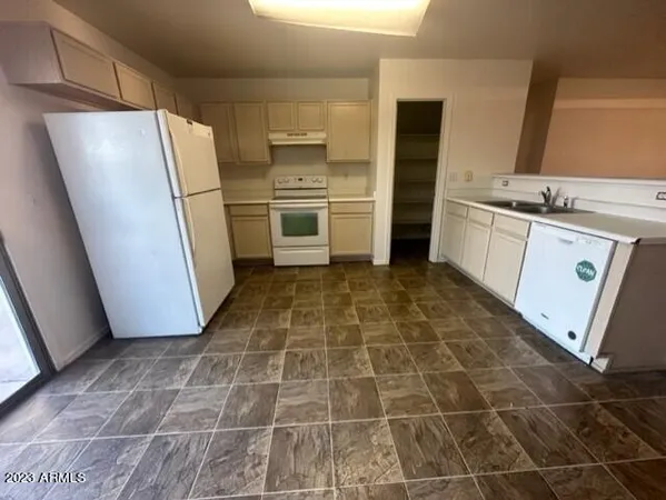 a kitchen with a stove a sink and a refrigerator