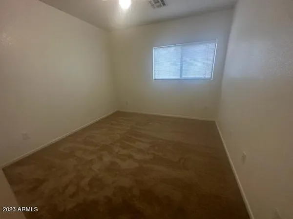 a view of an empty room with windows