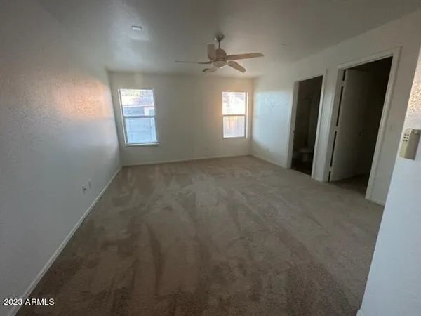 an empty room with windows and entrance