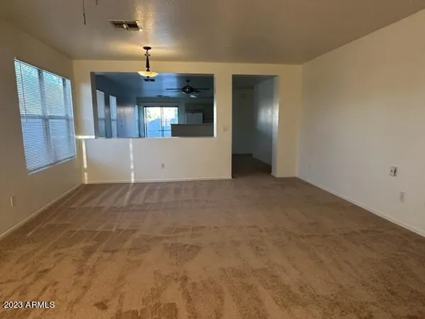 an empty room with windows and closet