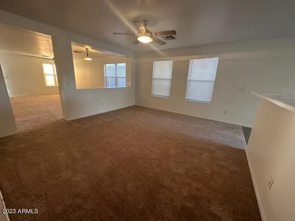 an empty room with a empty space and windows