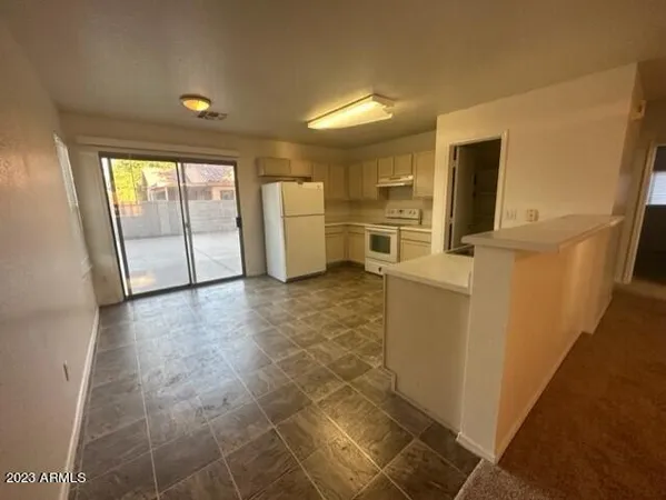 a kitchen with a refrigerator sink and stove
