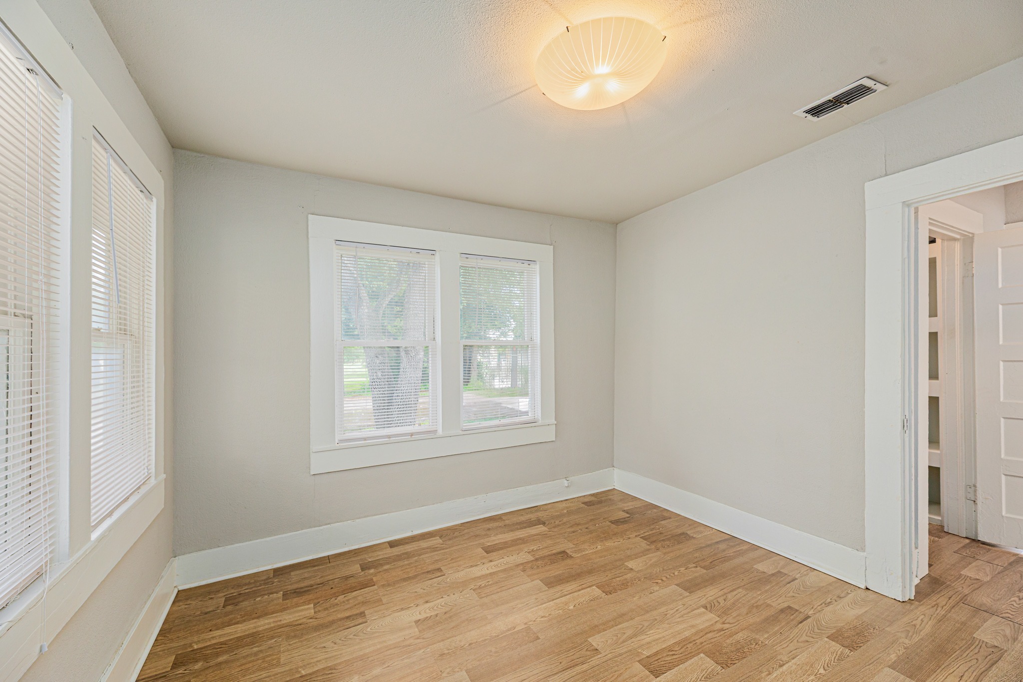 322 Blanco Avenue Luling, TX 78648 - Photo 14 of 20 Hardwood floors and natural light illuminate this adaptable living space.