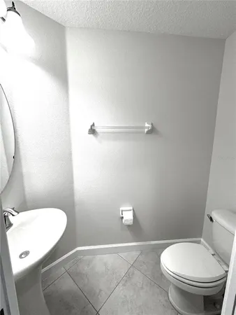 a bathroom with a toilet and a mirror
