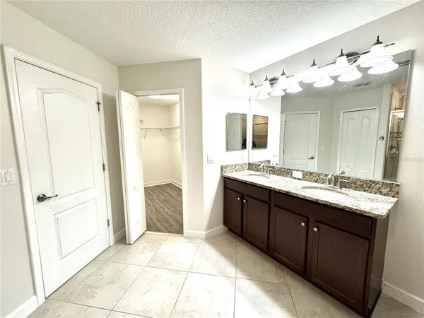 a bathroom with a double vanity sink mirror and