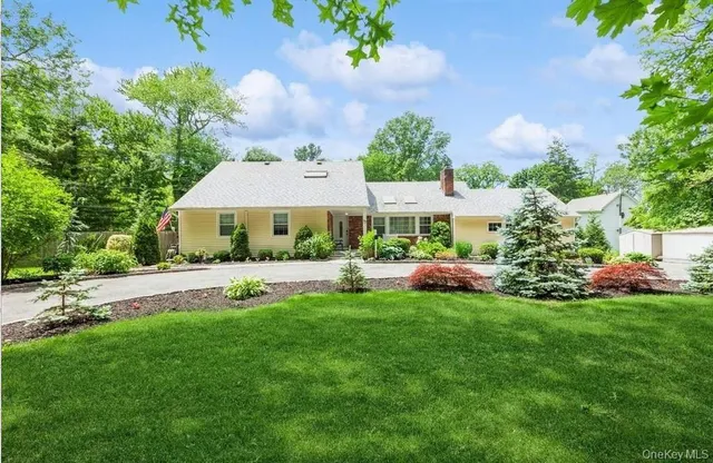 a view of a house with a yard and sitting area
