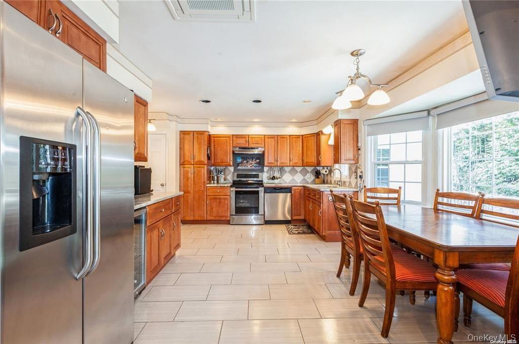 77 Duck Pond Road Glen Cove, NY 11542 - Photo 15 of 35 a large kitchen with a table and chairs