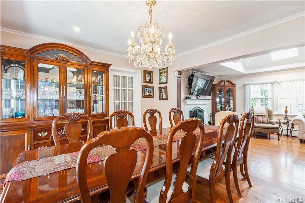 77 Duck Pond Road Glen Cove, NY 11542 - Photo 18 of 35 a view of a dining room with furniture large windows and wooden floor