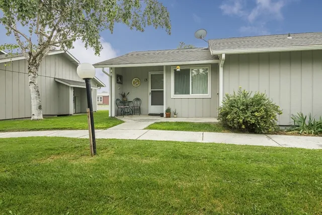a view of a house with a yard and porch