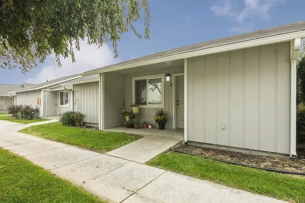 a backyard of a house with yard and outdoor seating
